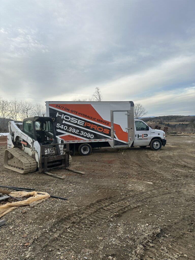 Truck on site to repair skid steer
