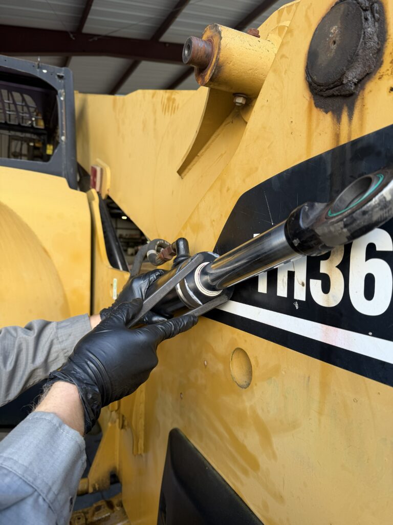 tech installing new hydraulic cylinder